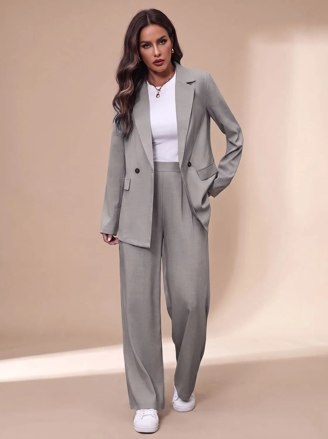 Model wearing a light grey double-breasted blazer and wide-leg trousers over a white top