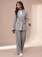Front angle of the light grey tailored suit set paired with white trainers and a white top