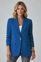 Woman wearing a tailored blazer with jeans, highlighting the classic office-ready fit