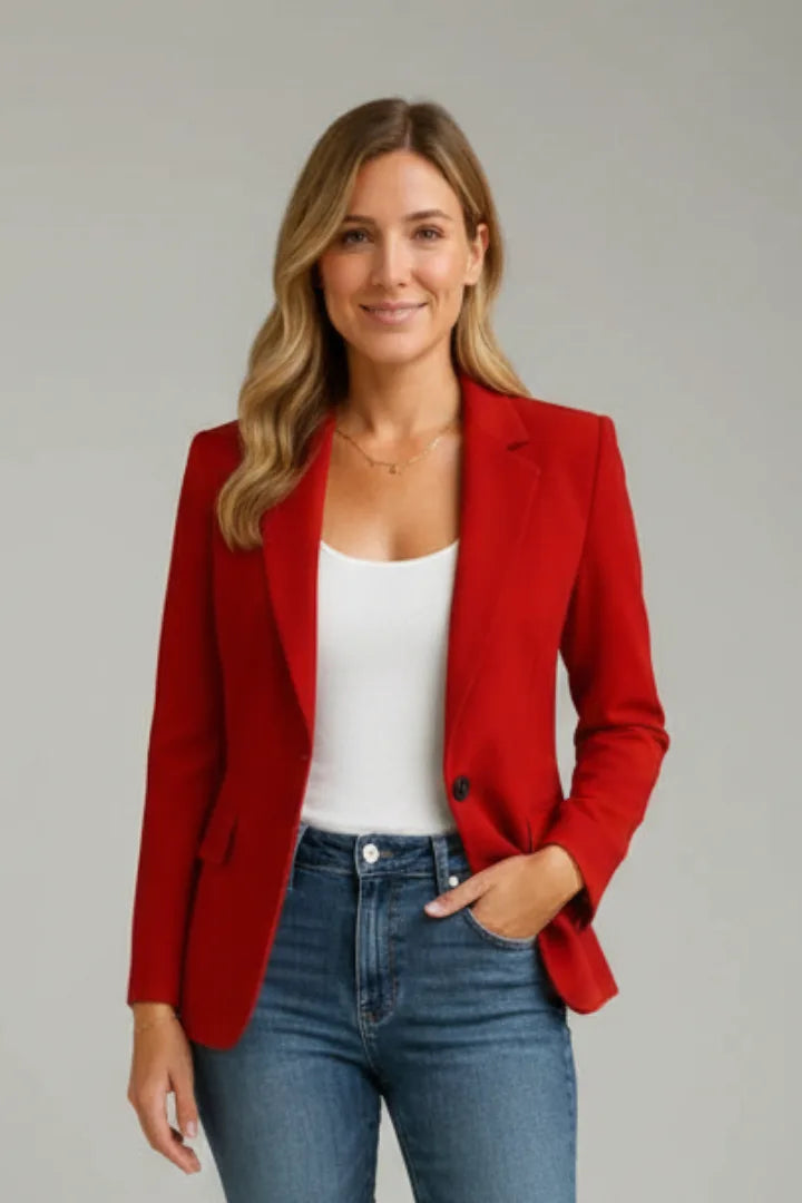Woman wearing a red single-button blazer over a white top and blue jeans, front view
