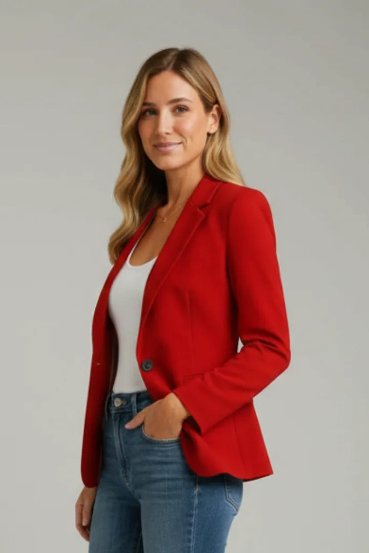 Three-quarter view of a woman wearing a red single-button blazer with a white top underneath