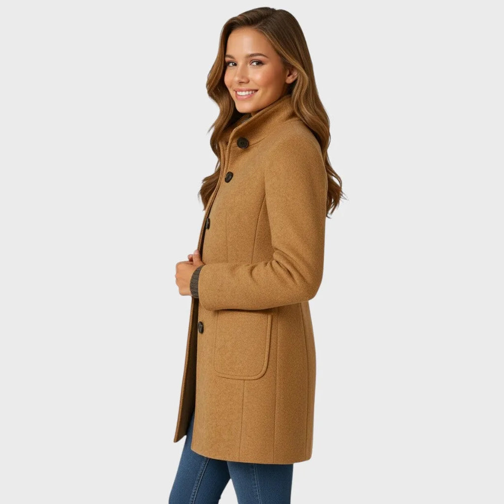 Side profile of the camel coat highlighting the stand collar, single-breasted buttons and patch pocket detail