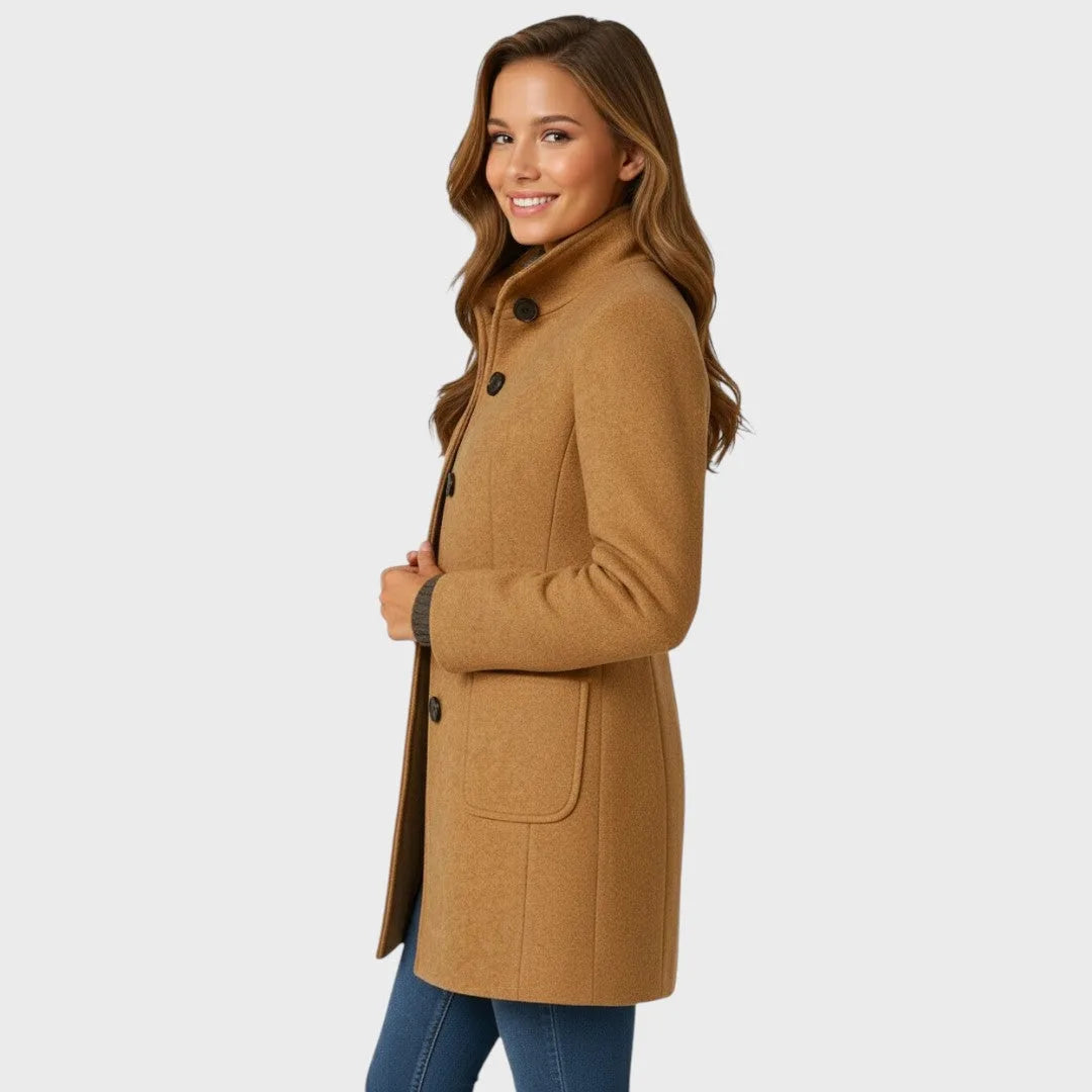 Side profile of the camel coat highlighting the stand collar, single-breasted buttons and patch pocket detail