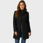 Charcoal wool coat with stand collar, single-breasted buttons and patch pockets, styled with jeans