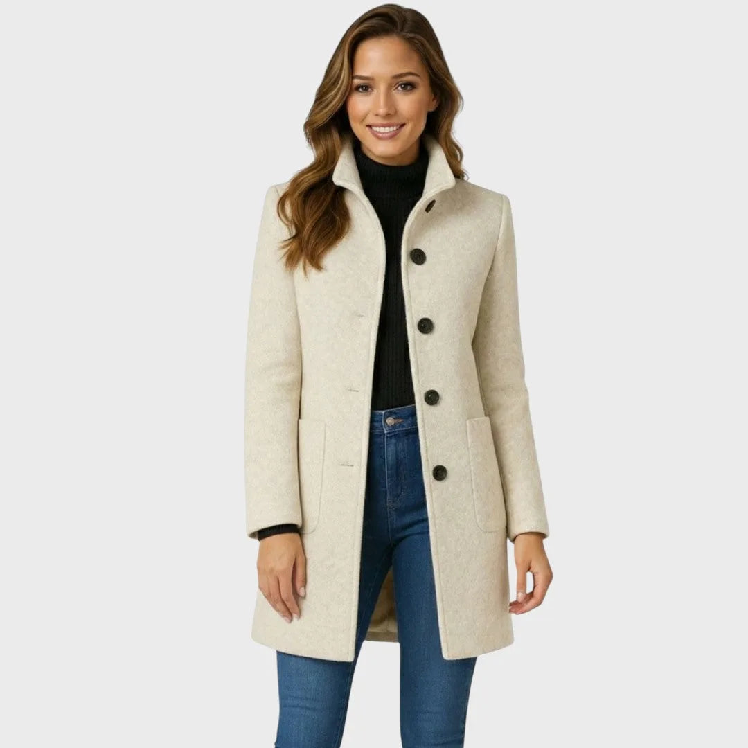 Beige wool coat with stand collar, button front and patch pockets, worn open over a black jumper