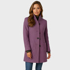 Mauve purple wool coat with stand collar and patch pockets, worn open over a brown ribbed knit