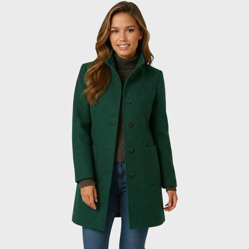 Front view of the tailored wool coat in a mid-length cut, showing the fitted silhouette and flap-style pockets