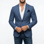 Blue tailored blazer fastened at the front, worn with a white shirt and dark jeans