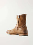 Back view of a tan suede biker boot with side zip fastening and visible stacked leather heel