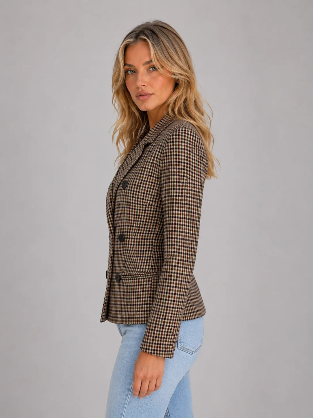 Side profile of the taupe checked double-breasted blazer highlighting the structured shoulder and notched lapel