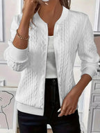 White cable knit-textured bomber jacket worn open over a white top, front view showing zip and ribbed collar