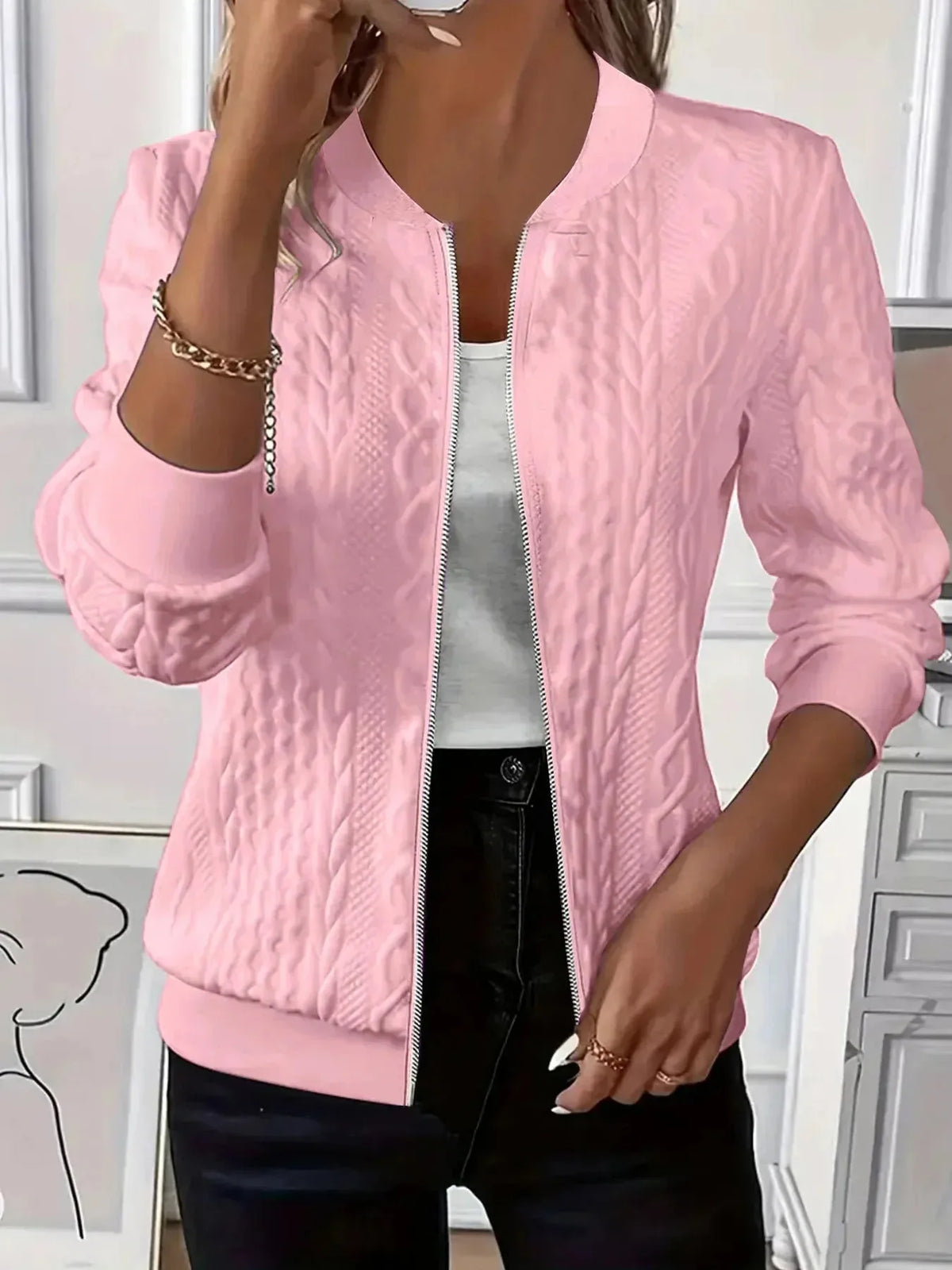Pink cable knit-textured bomber jacket worn open, front view showing zip closure and baseball collar