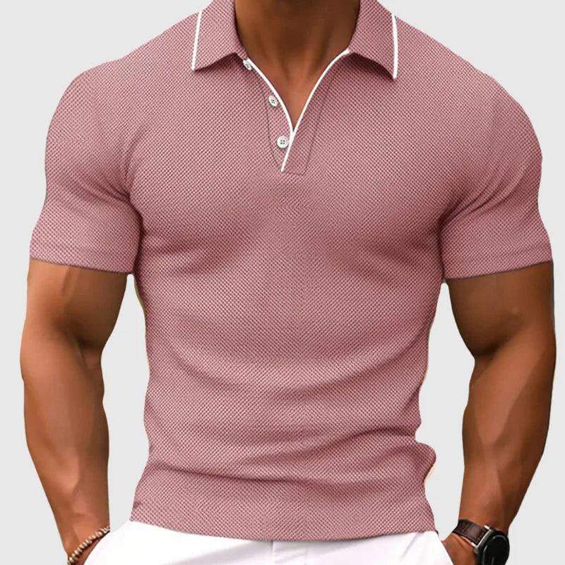 Close-up of a man wearing a dusty pink textured knit polo shirt with white contrast trim on the collar