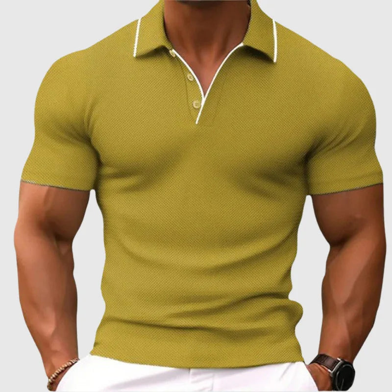 Man modelling an olive green textured knit polo shirt with short sleeves and open collar