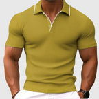 Man modelling an olive green textured knit polo shirt with short sleeves and open collar