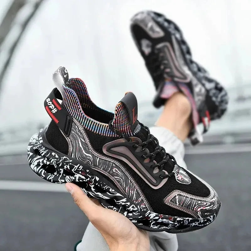 Black mesh trainers held in hand, showing the chunky sculpted sole and holographic side panel up close