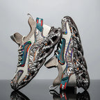 Pair of khaki and cream trainers with abstract swirl print standing on a reflective surface