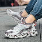 On-foot view of a white patterned trainer being laced up on a city pavement
