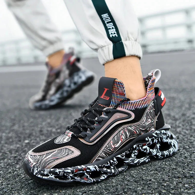 On-foot side view of a black trainer with holographic panel paired with jogging bottoms outdoors