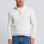 Off-white quarter-zip jumper with silver zip pull, shown unzipped at the neckline over a white t-shirt