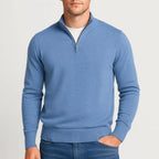 Soft blue heather quarter-zip jumper with hands tucked into denim trouser pockets