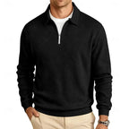 Black textured quarter-zip pullover with silver zip detail, front view with hand in pocket