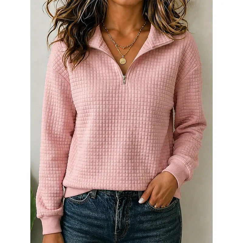Front view of a pink textured quarter-zip pullover with half-zip and stand collar