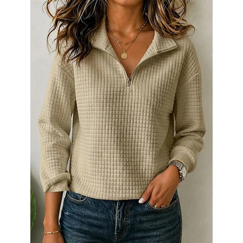 Front view of a camel textured quarter-zip pullover worn with denim jeans and a wristwatch