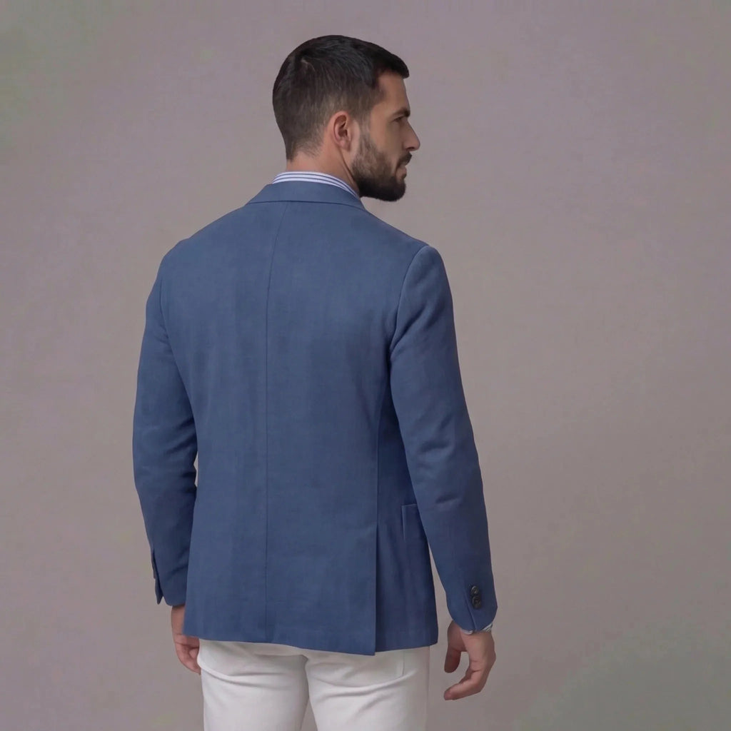 Back view of the blue blazer showing the single vent and clean shoulder seam detail