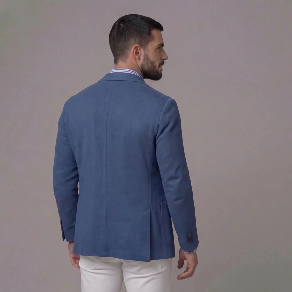Back view of the blue blazer showing the single vent and clean shoulder seam detail