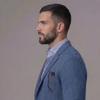 Profile view highlighting the notch lapel and patch chest pocket of the blue textured blazer