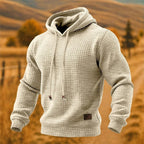 Apricot tone textured hoodie with waffle knit fabric, drawstring hood and ribbed cuffs