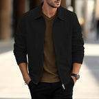 Black textured zip-up overshirt with collar detail, worn casually open over a brown top