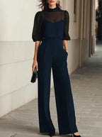 Navy three-piece set with sheer puff-sleeve blouse, camisole and high-waisted wide-leg trousers styled with heels