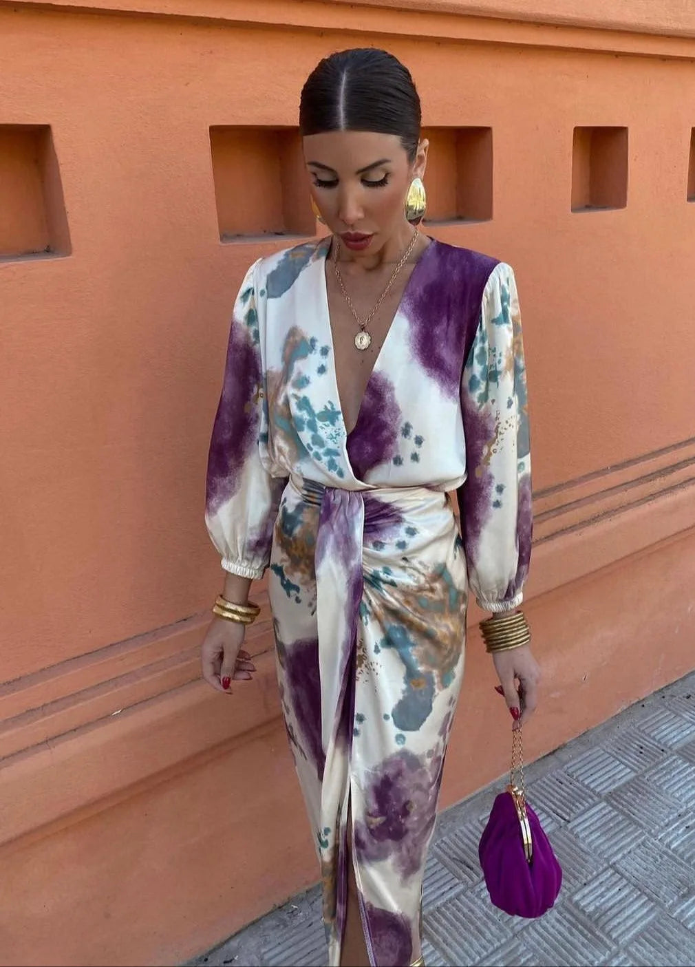 Front view of the wrap dress showing the tied waist sash, balloon sleeves with elastic cuffs and plunging neckline