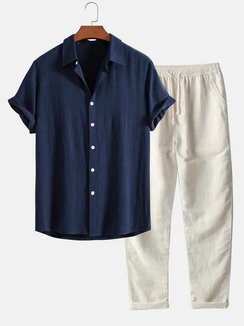 Navy blue linen-look shirt paired with cream drawstring trousers, close view of collar and cuffs