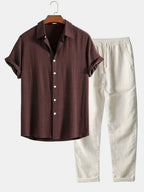 Dark brown short-sleeve shirt with classic collar and cream trousers, matching set on hanger