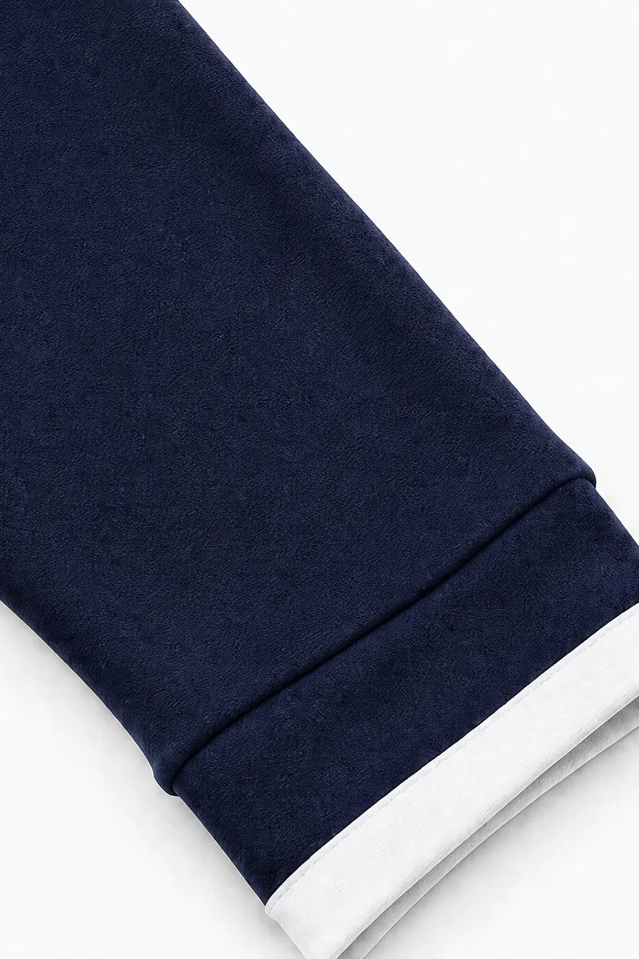 Close-up of the ribbed cuff hem in navy with contrasting white trim detailing