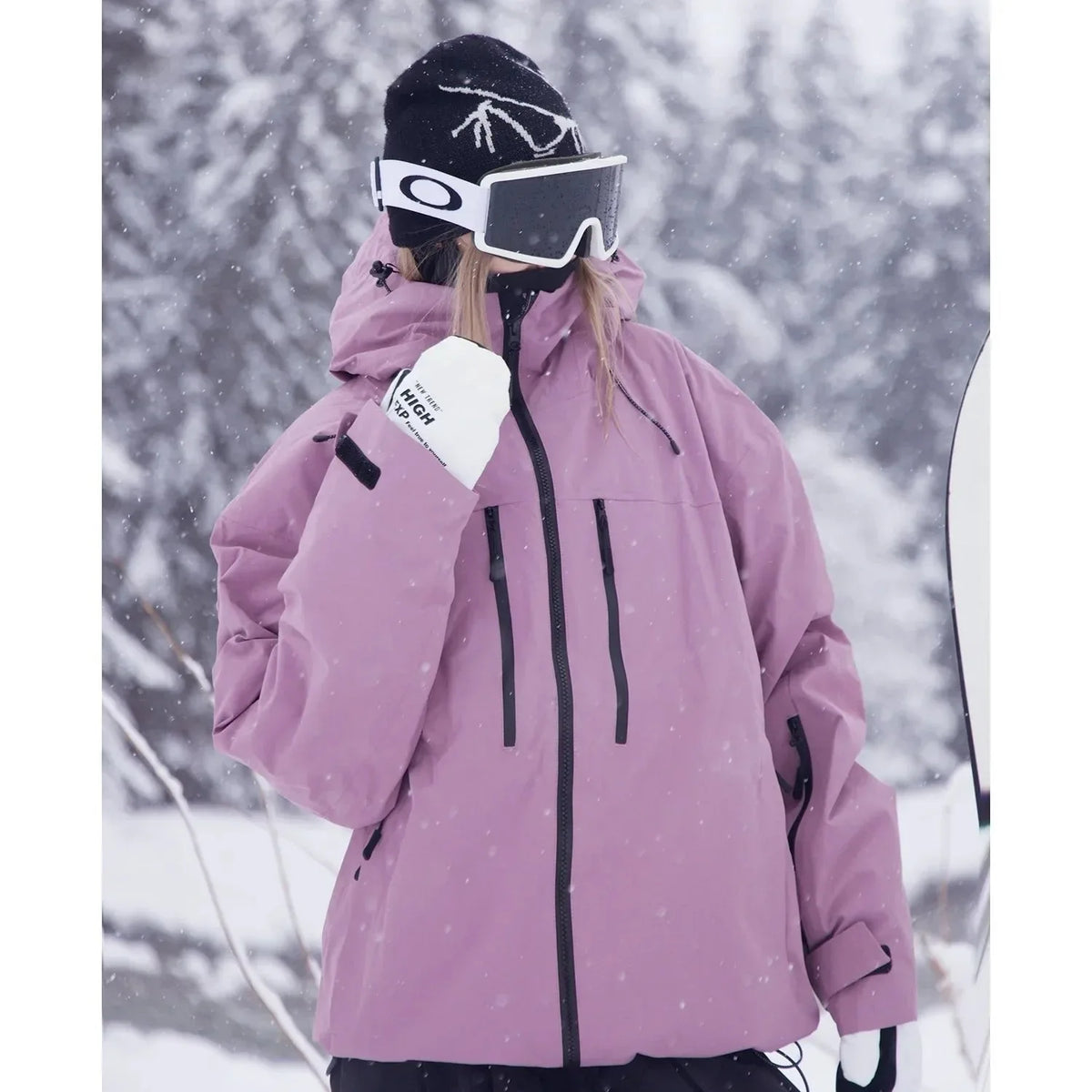 Side profile of a rose pink ski jacket showing the straight cut, chest pocket and centre zip closure