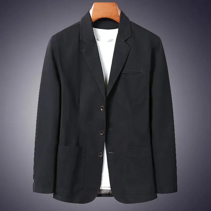 Black cotton blazer on a wooden hanger against a dark background, highlighting the notch lapel