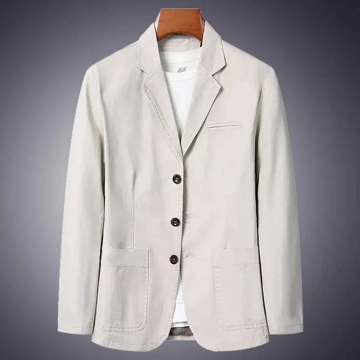 Beige cotton blazer on a wooden hanger against a dark background, front three-quarter view