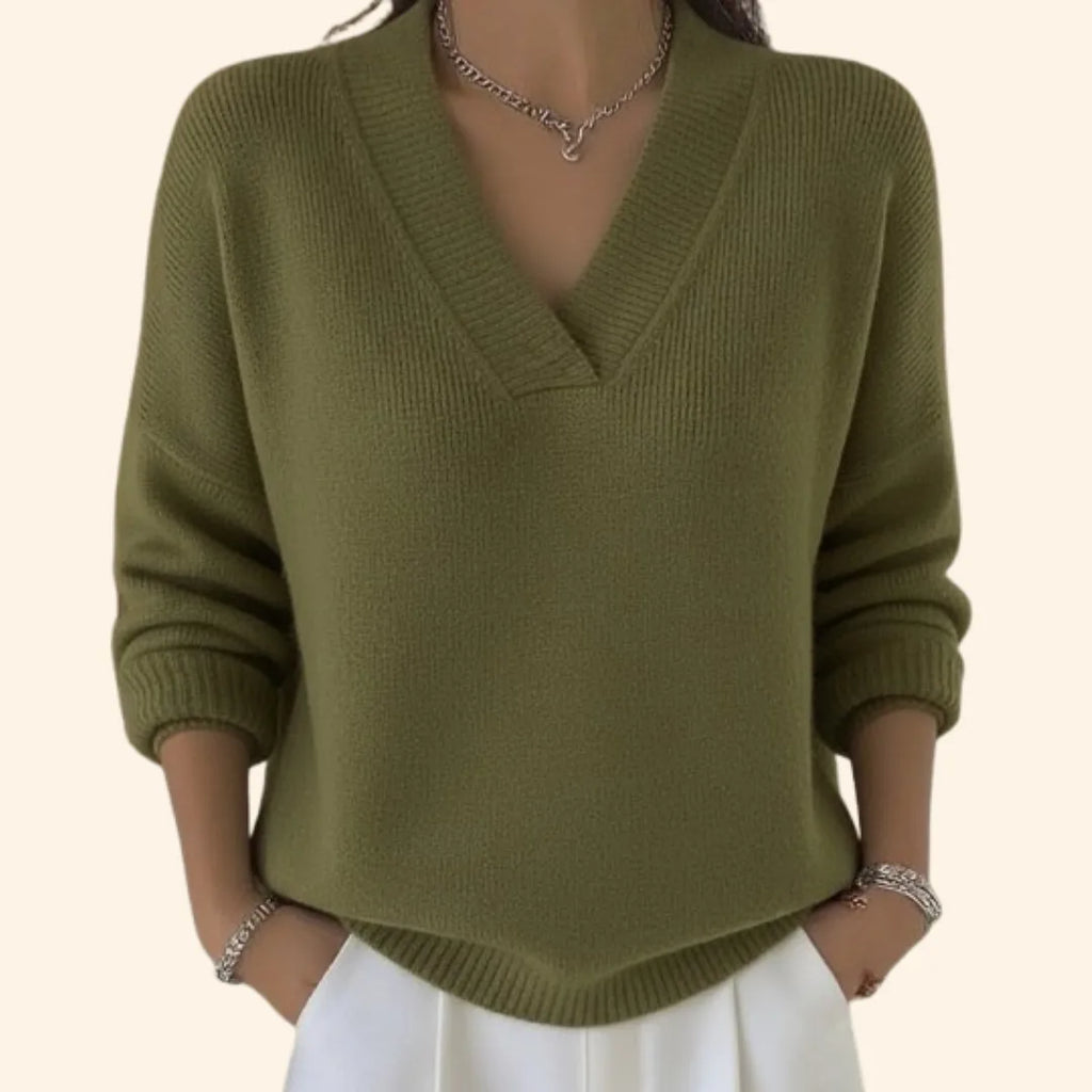 Woman modelling an olive green V-neck knit jumper with a wrap-style neckline and ribbed trims