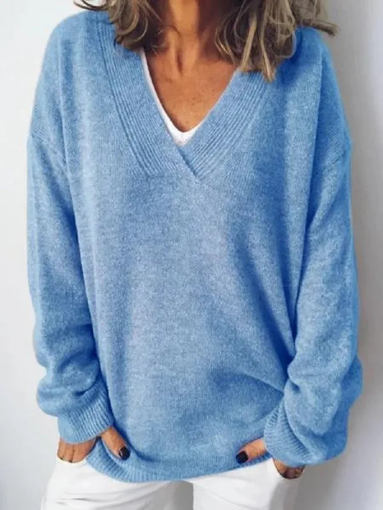 Close-up of a light blue oversized V-neck jumper showing the soft ribbed neckline detail