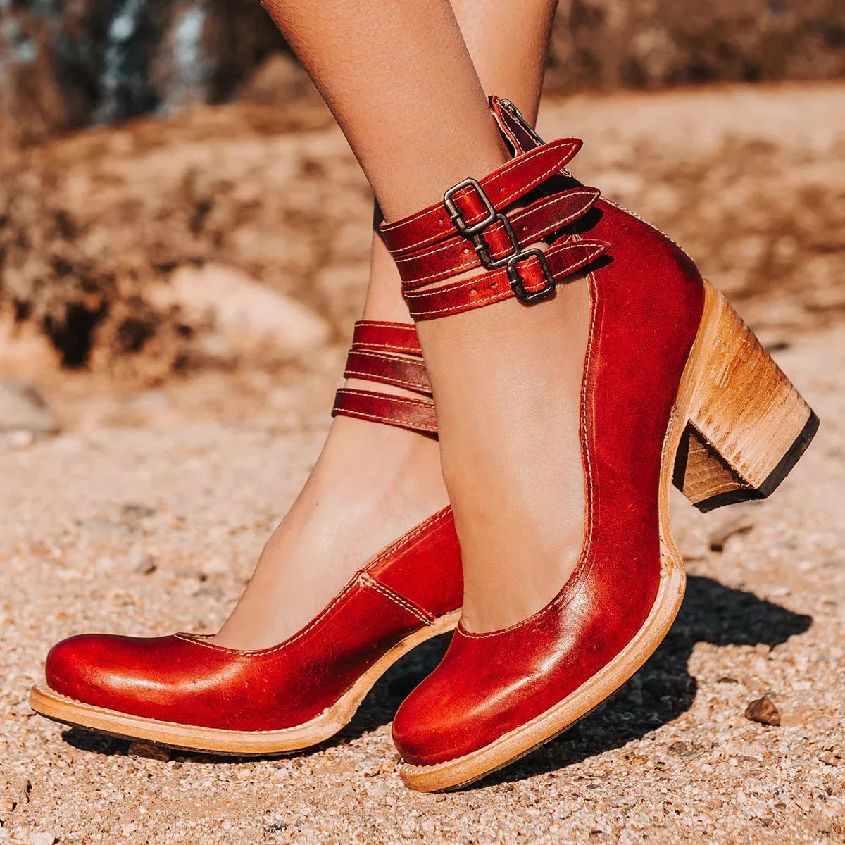 Red leather ankle strap heels with triple buckle straps and light wood-tone block heel
