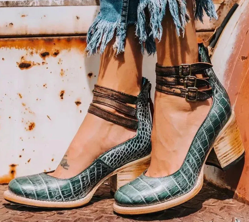 Green croc-embossed leather ankle strap heels with brown buckle straps and stacked block heel