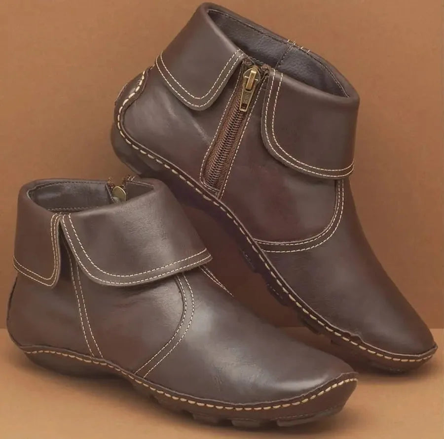 Dark brown leather ankle boots with foldover collar, zip fastening and cream stitched sole detail