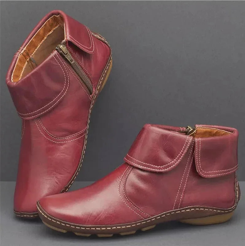 Deep red leather ankle boots with foldover collar, side zip and visible hand stitched trim