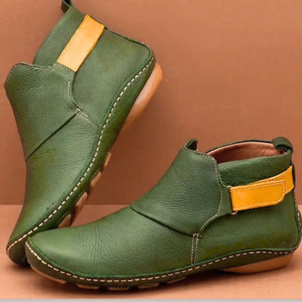 Green leather ankle boots with mustard yellow side tab, contrast stitching and slip-on style opening