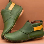 Green leather ankle boots with mustard yellow side tab, contrast stitching and slip-on style opening