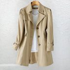 Front view of khaki trench coat fully buttoned, showing collar, side pockets and cuff buttons